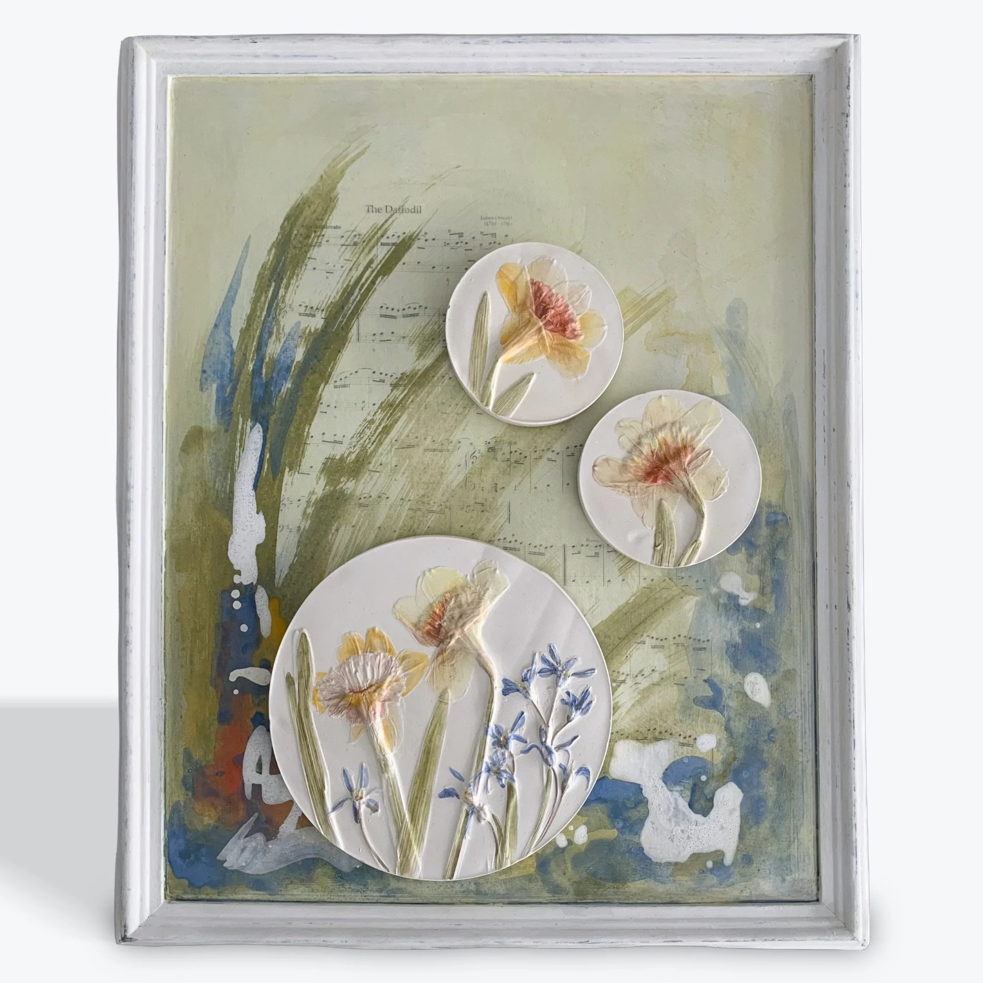  First Song, plaster-of-paris, milk-paint, ink transfer on repurposed wood frame, 22.5in x 18.5in x 2in (ready to hang with picture-wire on back)  Daffodils are one of the first showy flowers that greet us in the spring. These flowers were captured d