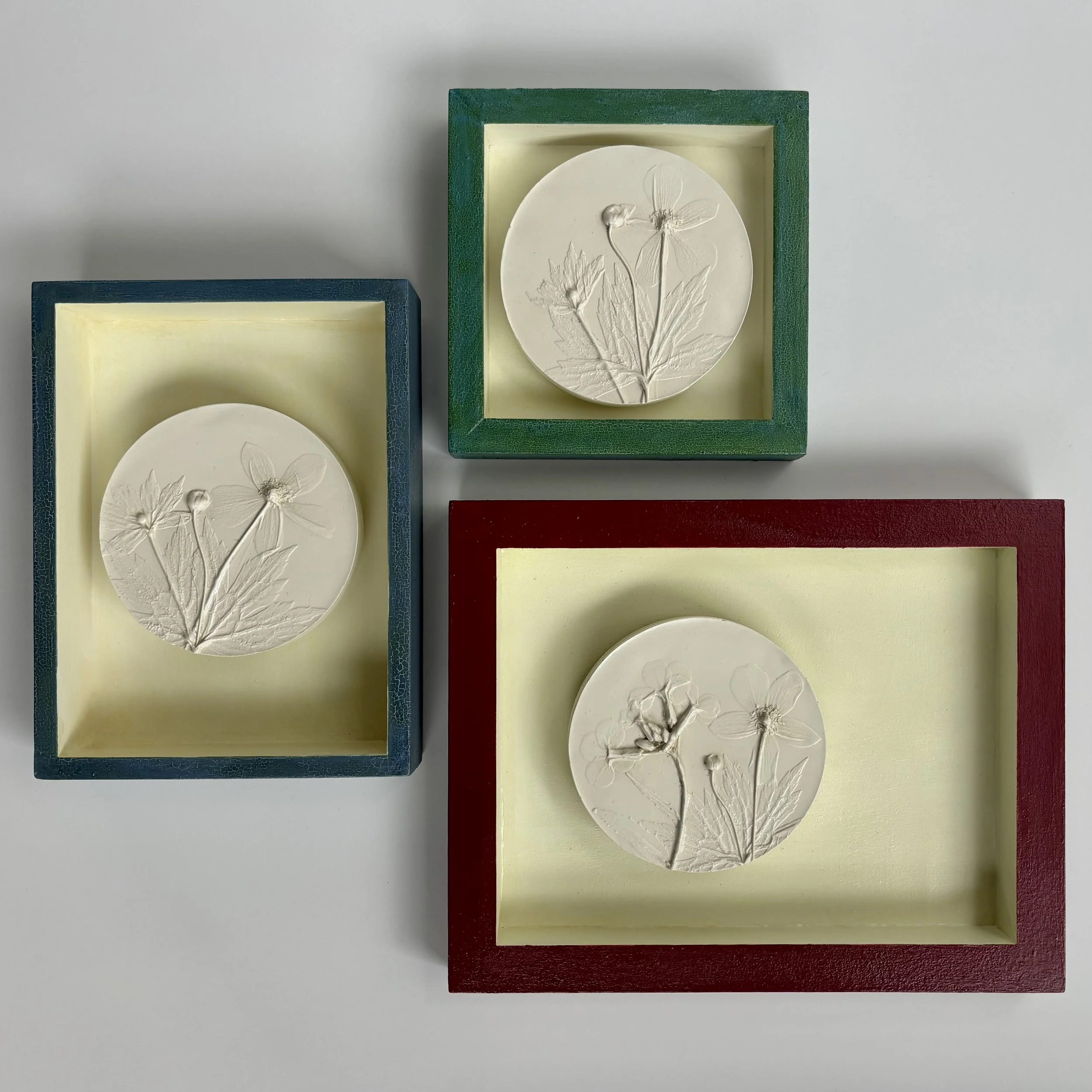  Sweet Beginnings, plaster, milk-paint on wood frame, various sizes, (ready to hang with picture-wire on back)  Add a touch of whimsy to your home with Sweet Beginnings. These one-of-a-kind pieces feature botanical casts created from vibrant flowers 