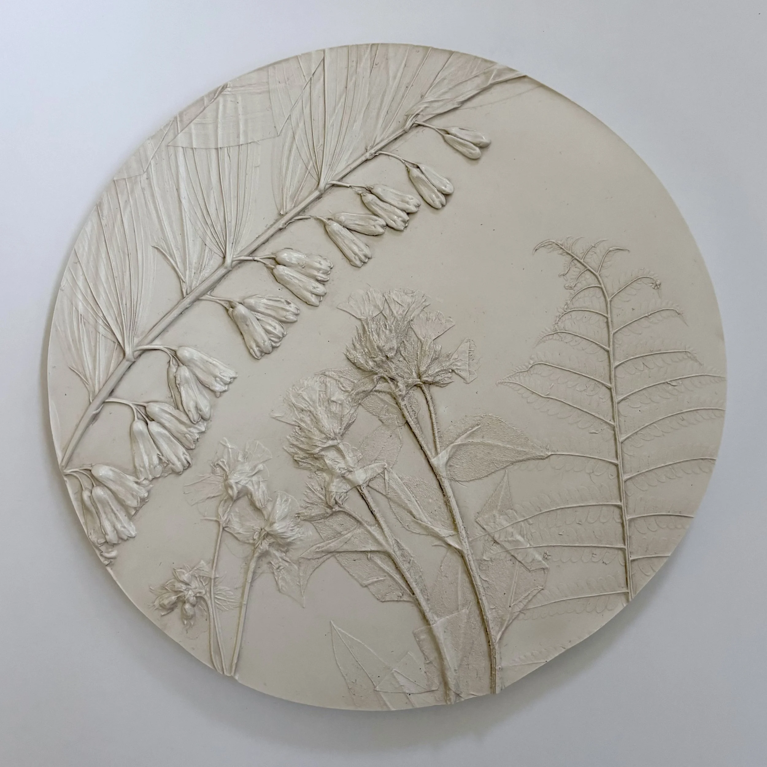  A Quiet Unfurl No. 1, milk-paint topcoat on hydrostone, 9.75in round x 0.6in (ready to hang with picture-wire on back)   This artwork captures a serene moment in nature, blending soft botanicals and delicate plants to evoke a sense of calm and intro