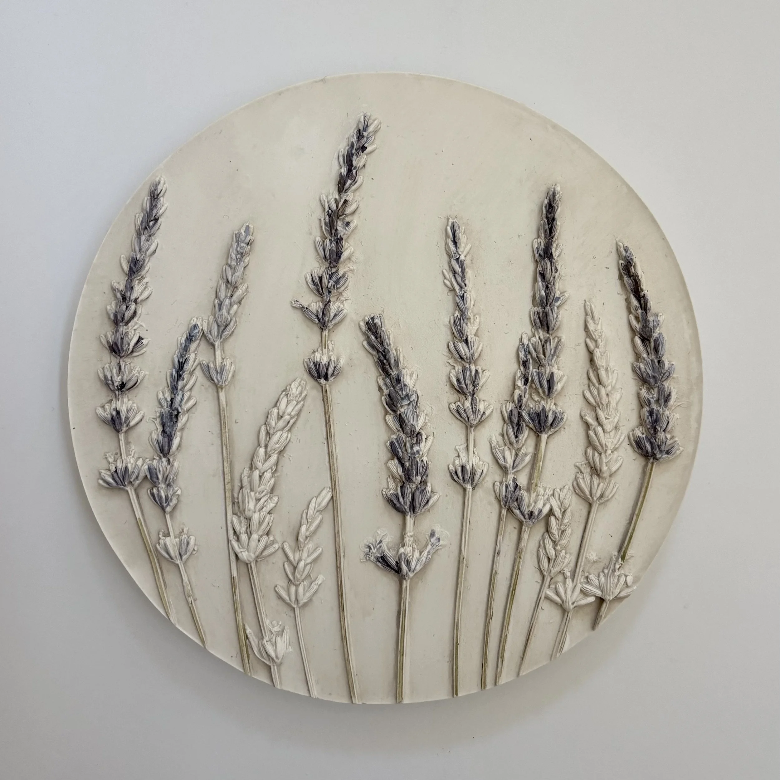  Phenomenal Field, milk-paint pigment and topcoat on hydrostone, 6.5in round x 0.5in (ready to hang with picture-wire on back)    Add calming elegance with this lavender wall hanging. Its soft hues and delicate design bring a serene, natural vibe to 