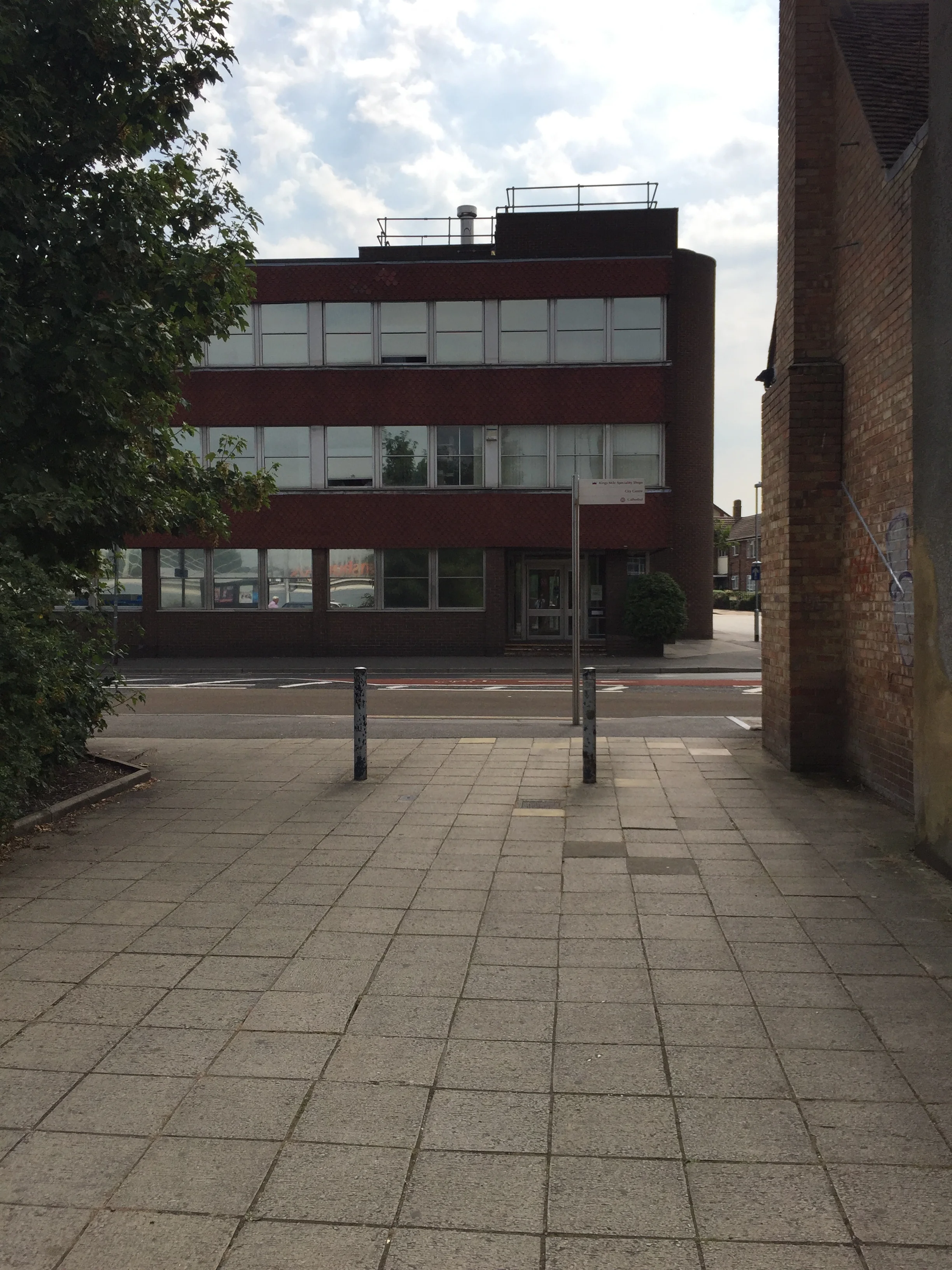Proceed along the walkway until you reach the road (Northgate).