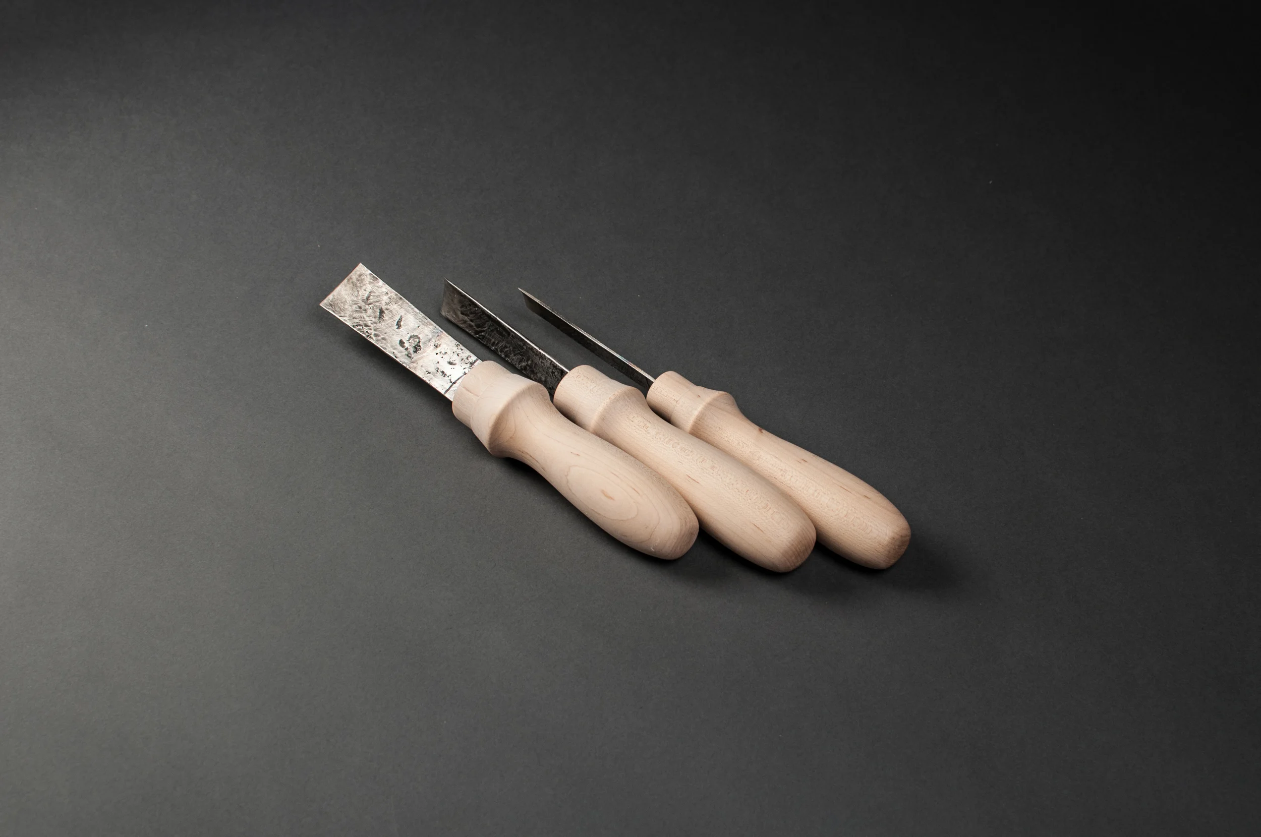 Hand-turned maple handles. McCurdy acquired a set of hand forged chisels and gauges in Bali in 2011. She made handles for three of them in 2016 to demonstrate capability on a wood lathe.