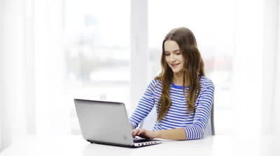 stock-footage-home-education-technology-and-internet-concept-smiling-teenage-girl-with-laptop-computer-at-home.jpg