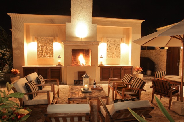 Living area shown at night with fire and candles for romantic, luxury vacation