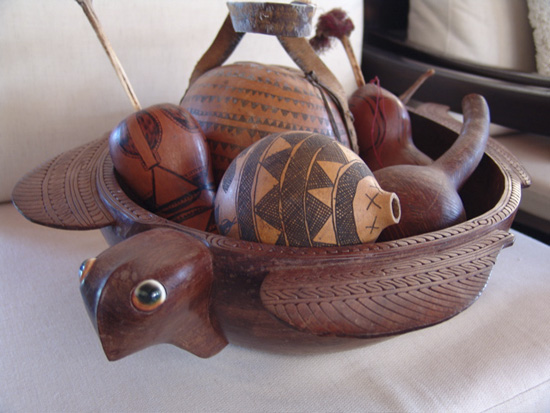  Various gourds and lime juice holders (Africa and Papua New Guinea)&nbsp;in a carved turtle bowl from Papua New Guinea. 