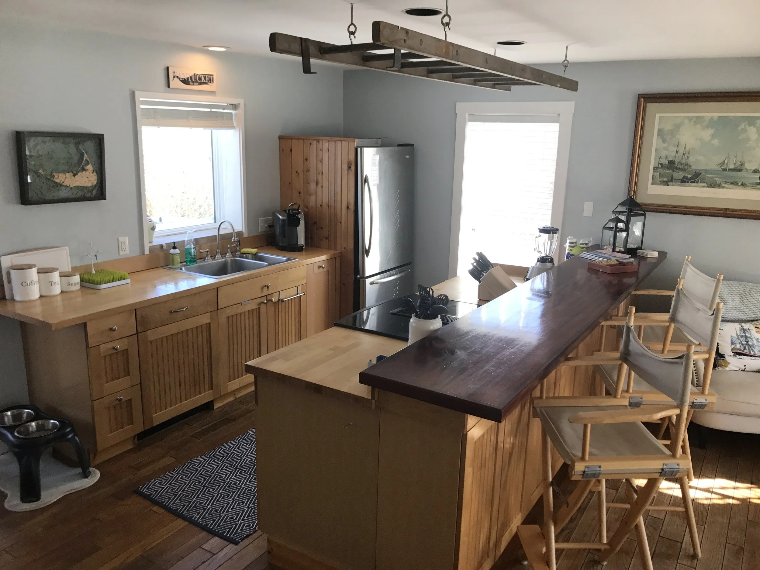 Open kitchen with counter seating flows into large main living space