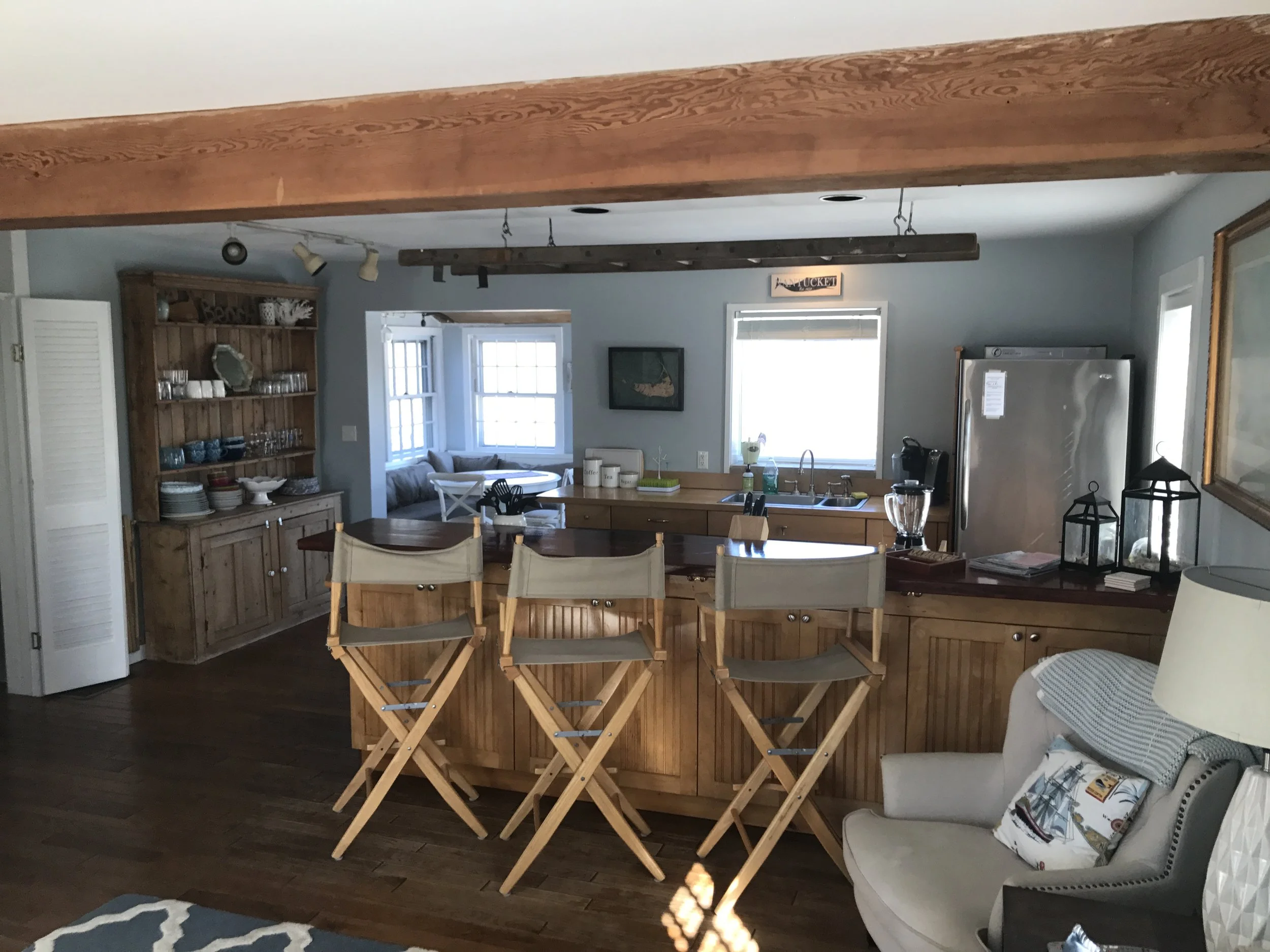 View from Living room to open kitchen with dining nook to the back.  "Welsh Dresser" with plate/glass storage