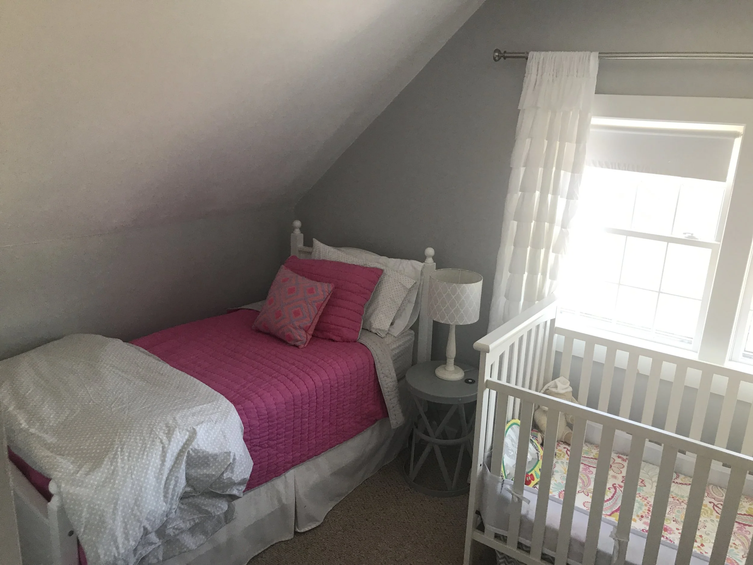 Upstairs bedroom with two twin beds and crib