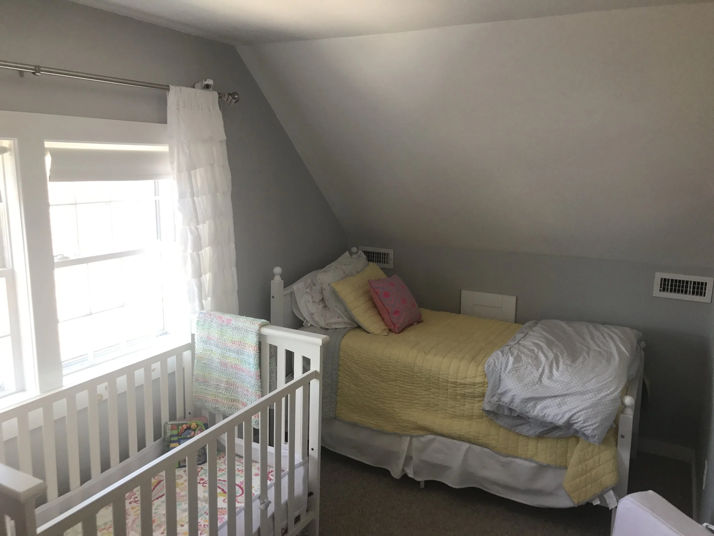 Upstairs bedroom with two twin beds and crib