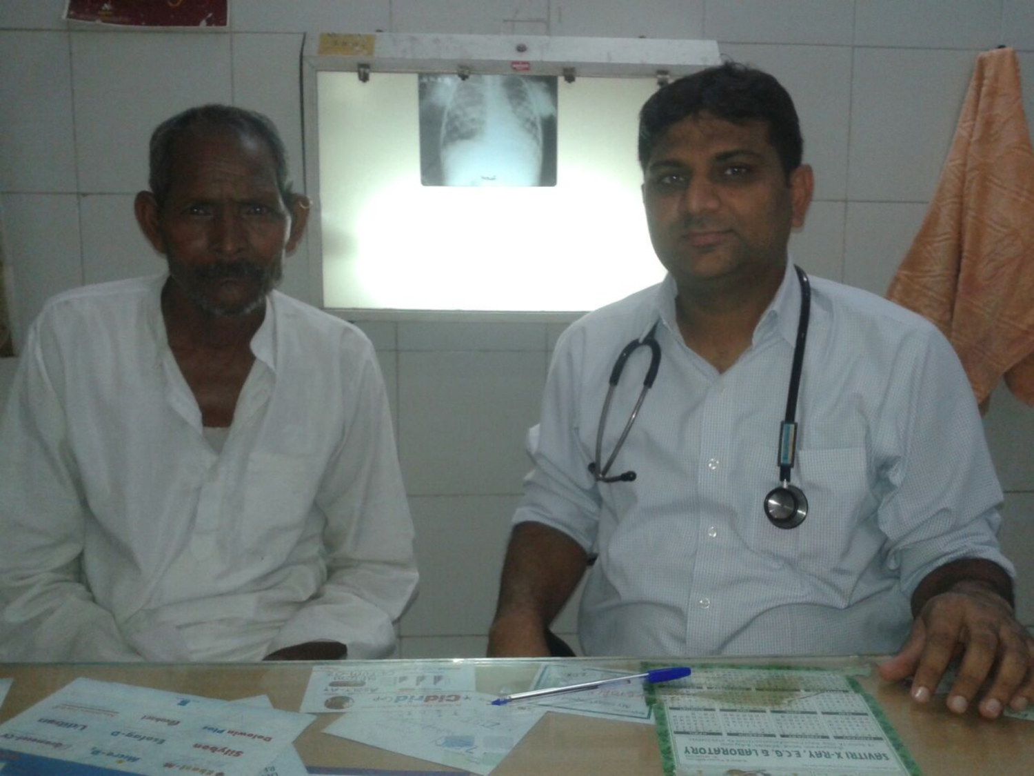 Hazari (left) is 70 years old and has pulmonary tuberculosis, which results in violent coughing spasms and fevers. Dr. Prabhat (right) diagnosed Hazari with the help of an x-ray that was paid for by one our donors. 
