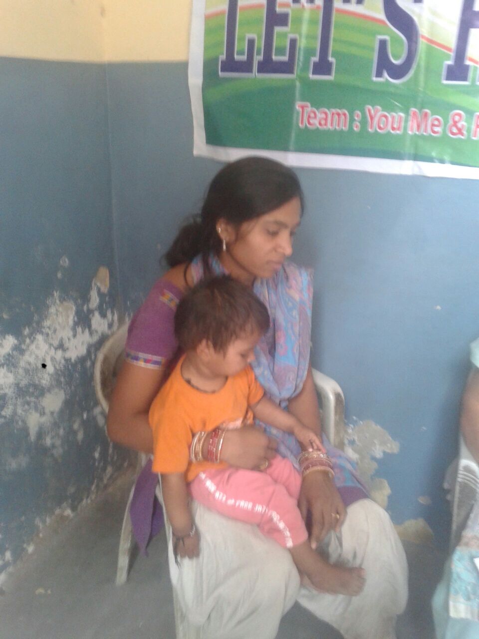 Suman is 26 years old and has had a low grade fever for the past two months. In her lap, is Takshak. He is her sister's son. Her sister passed away from tuberculosis 6 months ago.