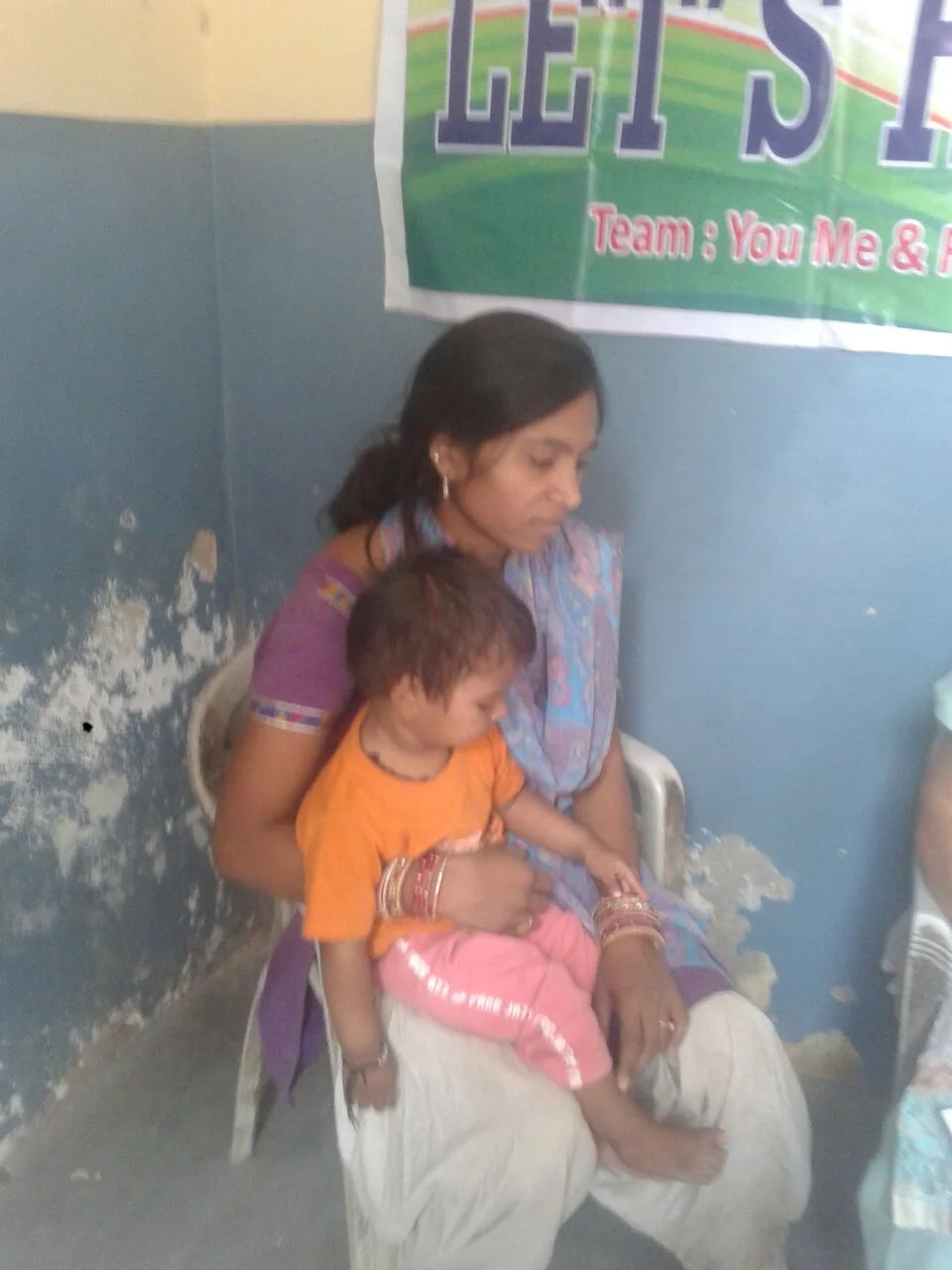 Suman is 26 years old and has had a low grade fever for the past two months. In her lap, is Takshak. He is her sister's son. Her sister passed away from tuberculosis 6 months ago.