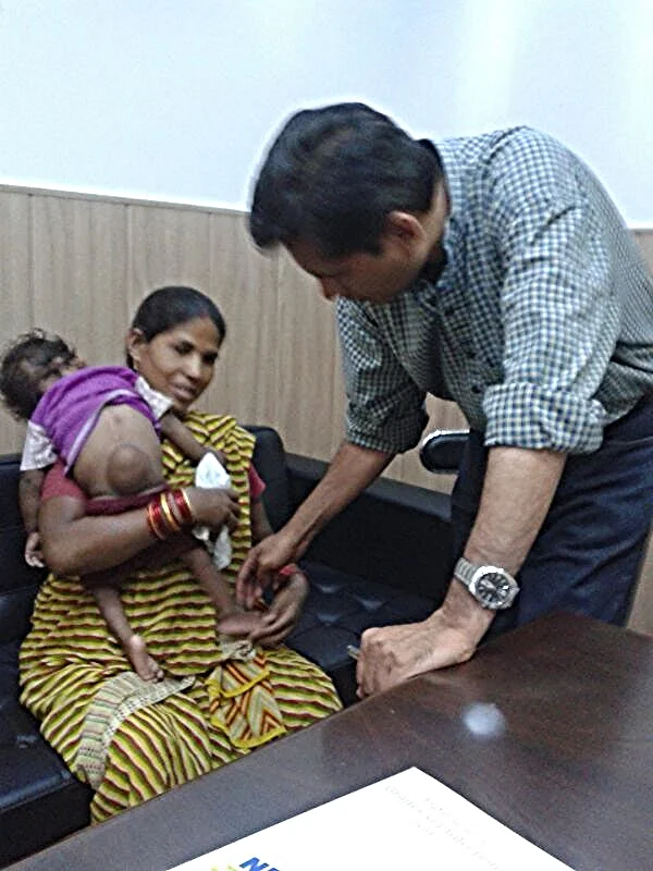 Dr. Pakash, one of our volunteers, visits with Ankush (left) and his mother (middle). Ankush suffered from spina bifida. With the help of our donors, we sponsored a surgery for Ankush and his spine was fixed. 