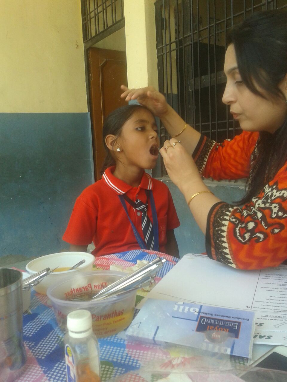 Meet Malti. She is 8 years old. Shiva, our volunteer dentist, examines Malti's teeth for cavities.