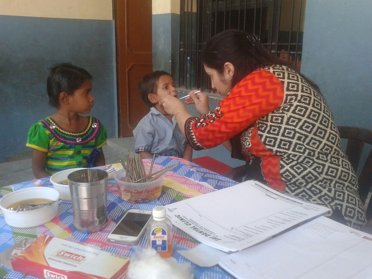 Linu (right) is 5 years old. He was anxious about seeing a dentist. He had never heard of a doctor or medicine before. His sister, Rea, sat next to him during his visit. This calmed him. 
