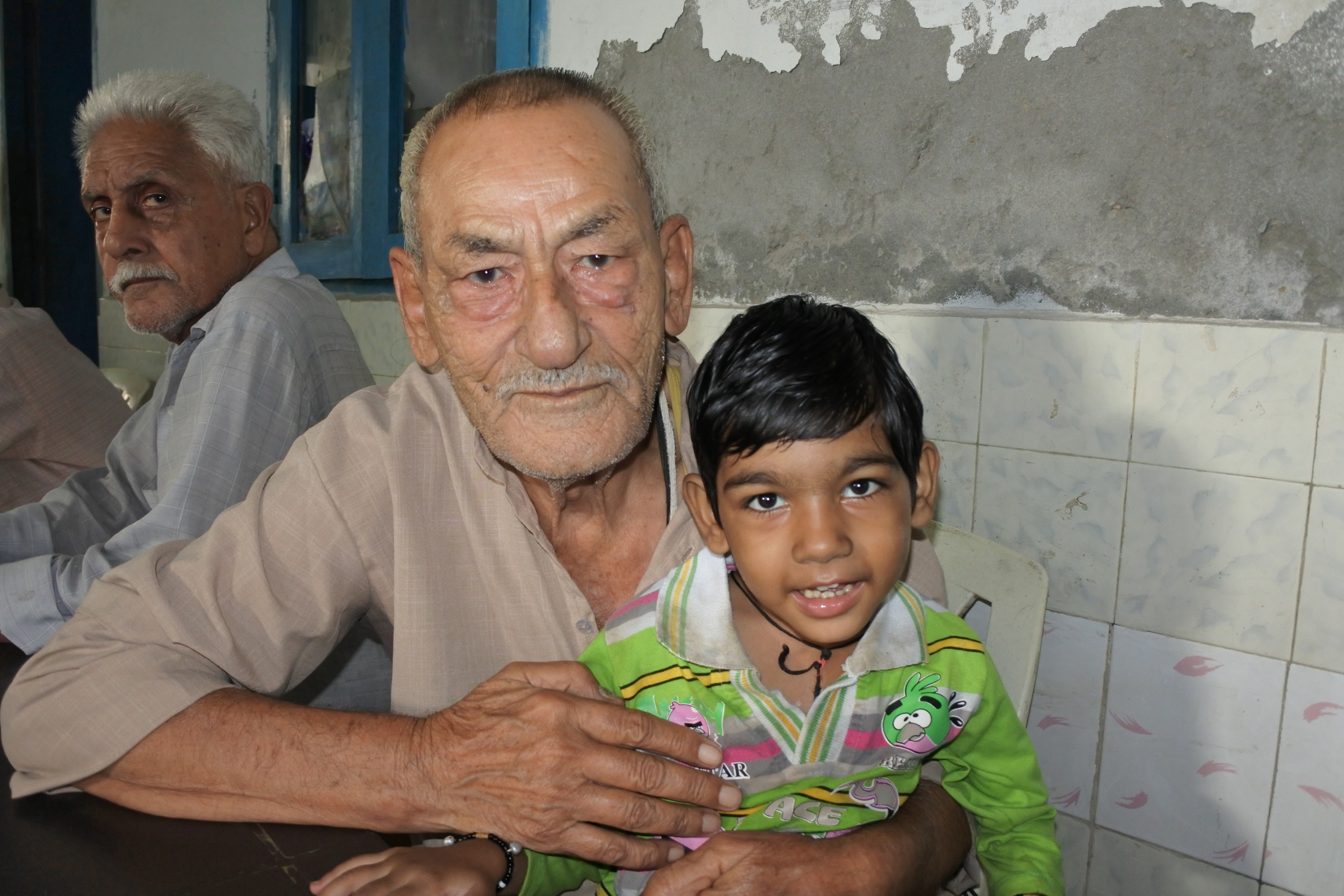 In this photo, Nikhil (left) and Rishi (right). Rishi is Nikhil's grandson. Nikhil is 62 years old. He has colon cancer; however, the tumor may be removed with surgery. With successful surgery, Nikhil will hopefully enter remission. 