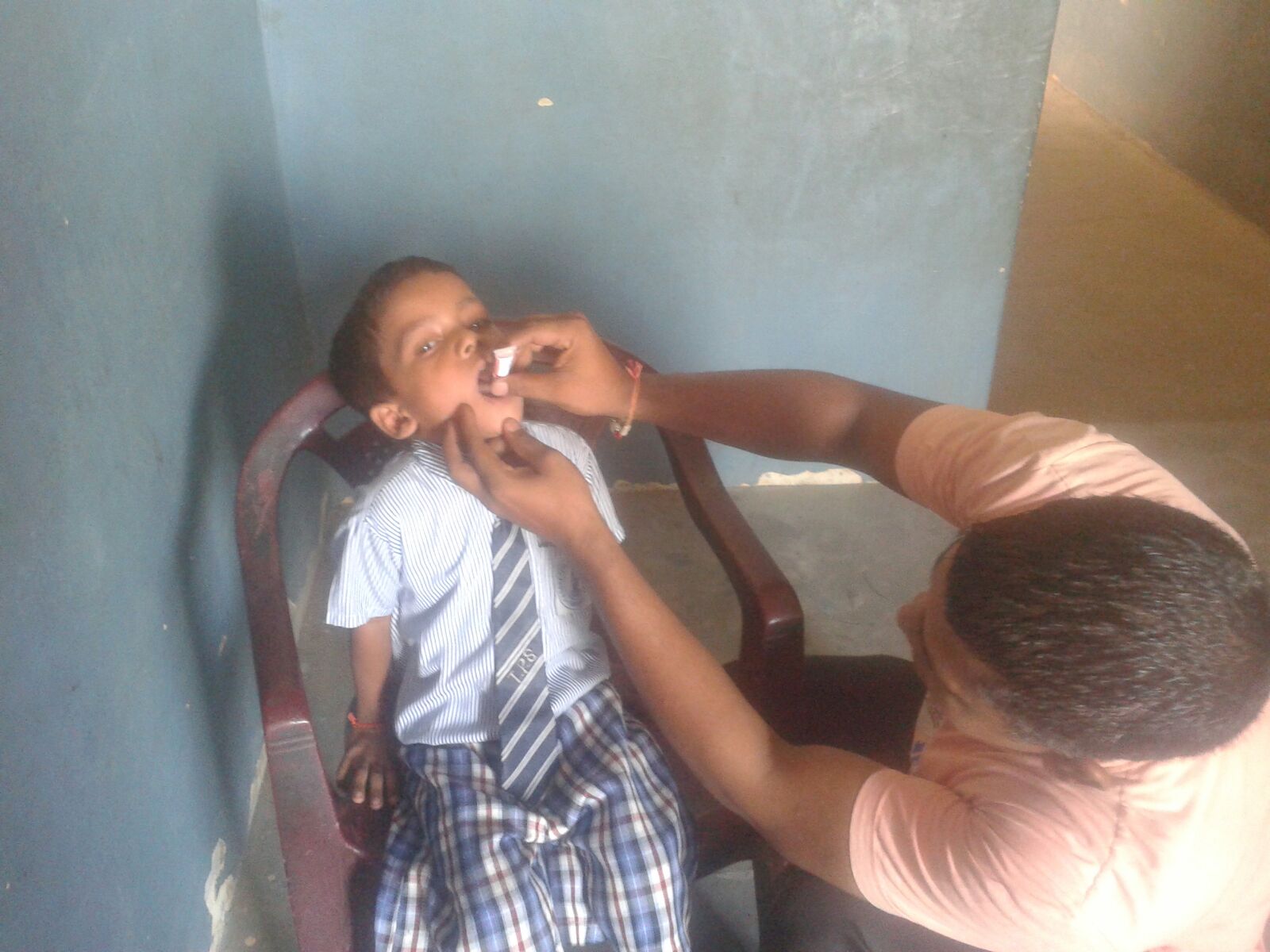 Narendar is 5 years old. He is receiving his oral vaccines in this picture. He took part in our health camp for children under 6 years old. 