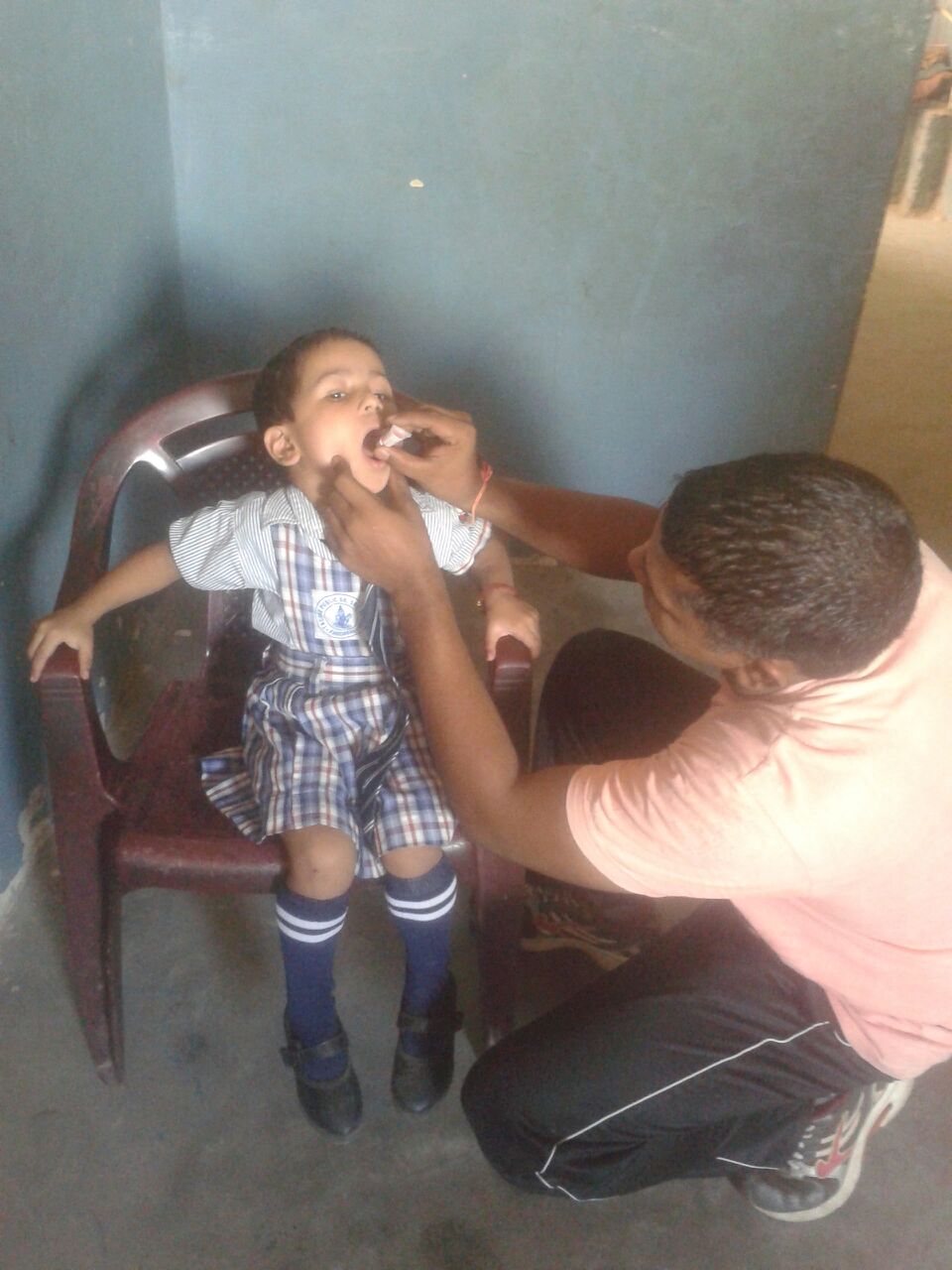 Sibani is 4 years old. She is being given oral vaccines in this picture. She is undernourished and requires nutritional supplements. 