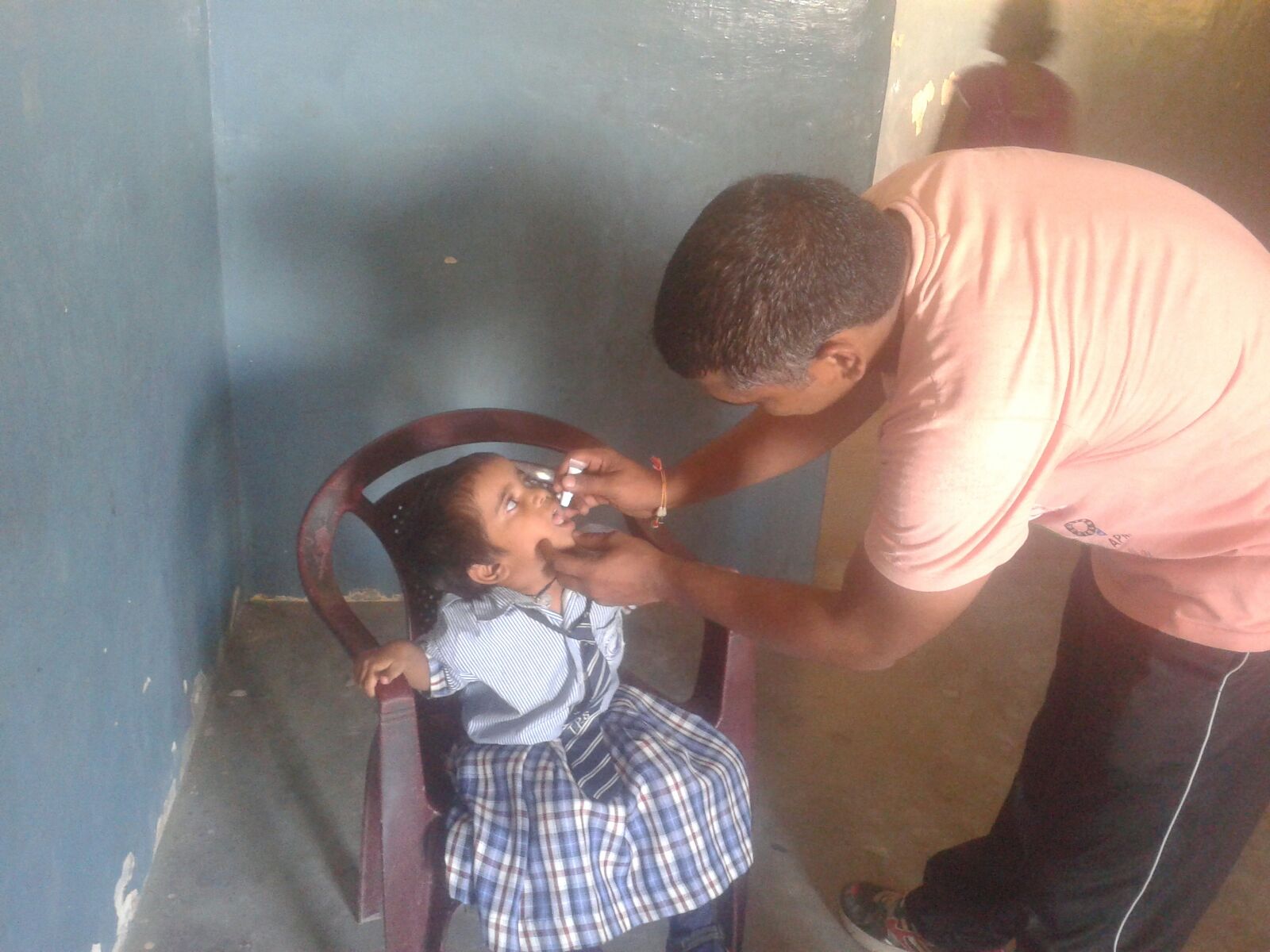 Eila is 3 years old. She is receiving oral vaccines in this picture.