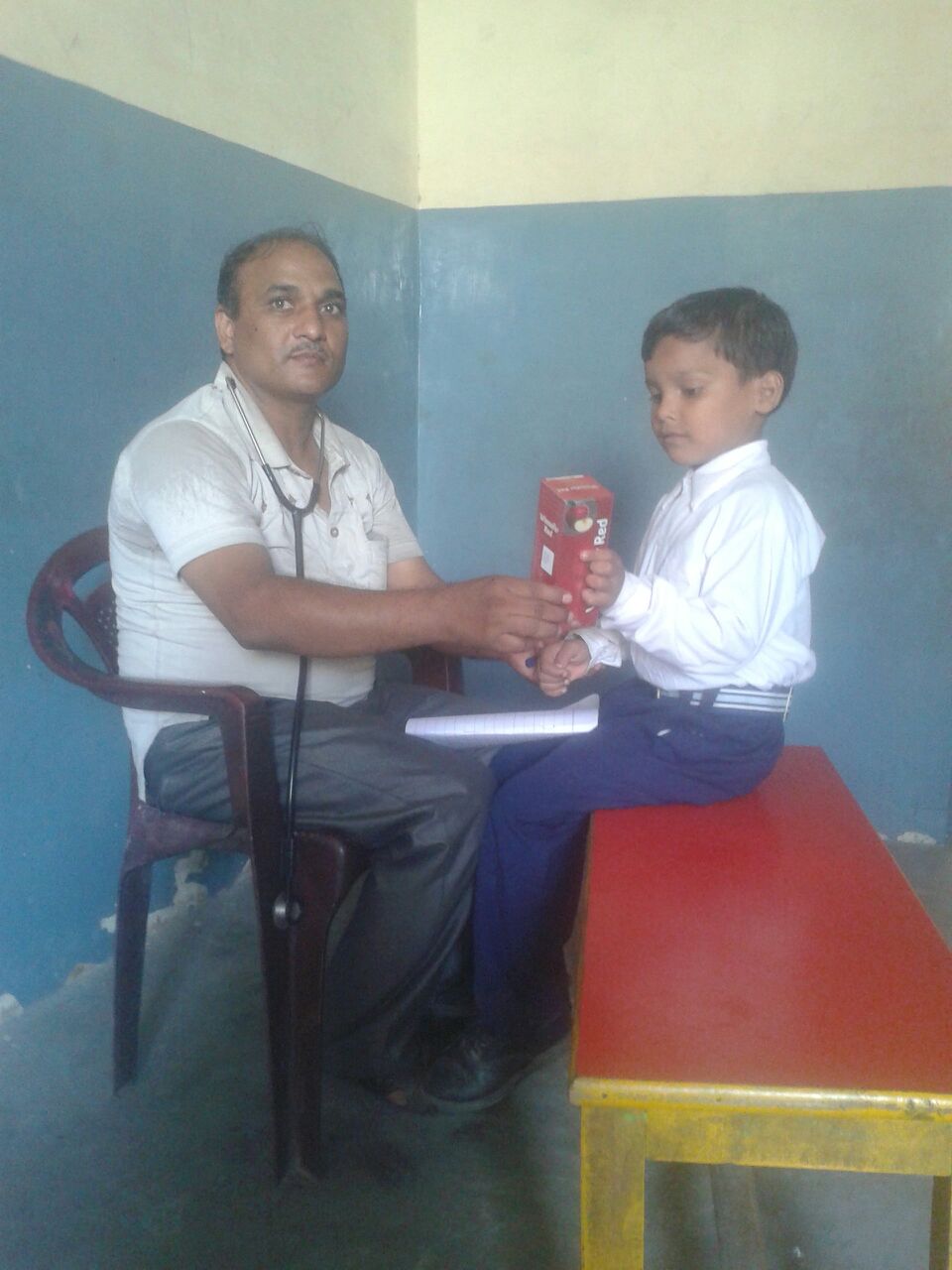 This is Jay, and he is 7 years old. He suffers from malnutrition. He is holding a case of protein powder that we gave him. He requires additional nutritional supplements. 
