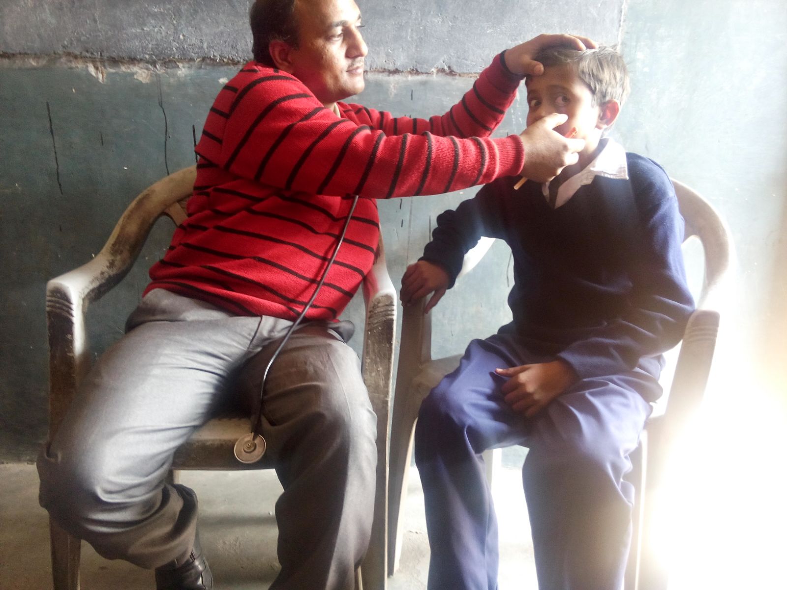 This is Hiran, and he suffers from dry eyes. He works with his father as a laborer before and after school. He has one older brother, who also works with them. 