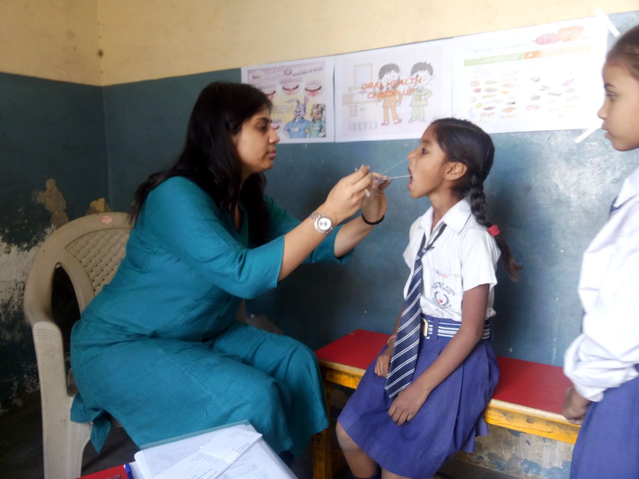 Meet Akshara, a 10 year old girl. She has never before seen a dentist, prior to this dental health camp. 
