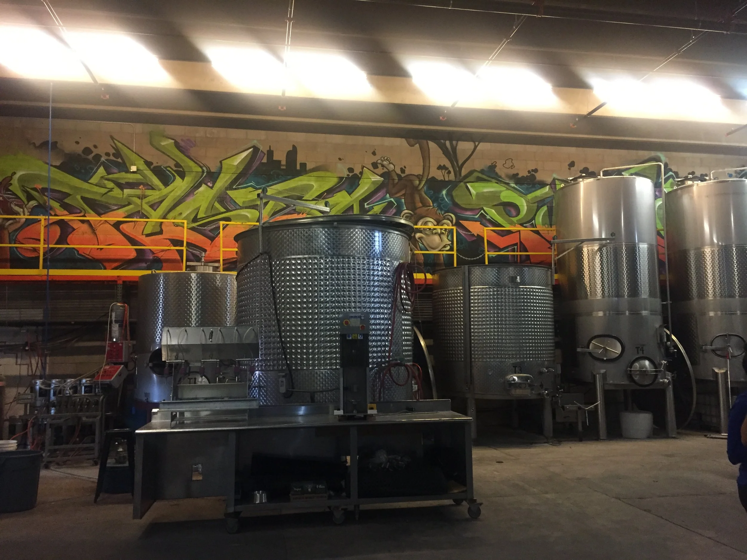 The fermentation tanks and some artful "tagging" in the background.