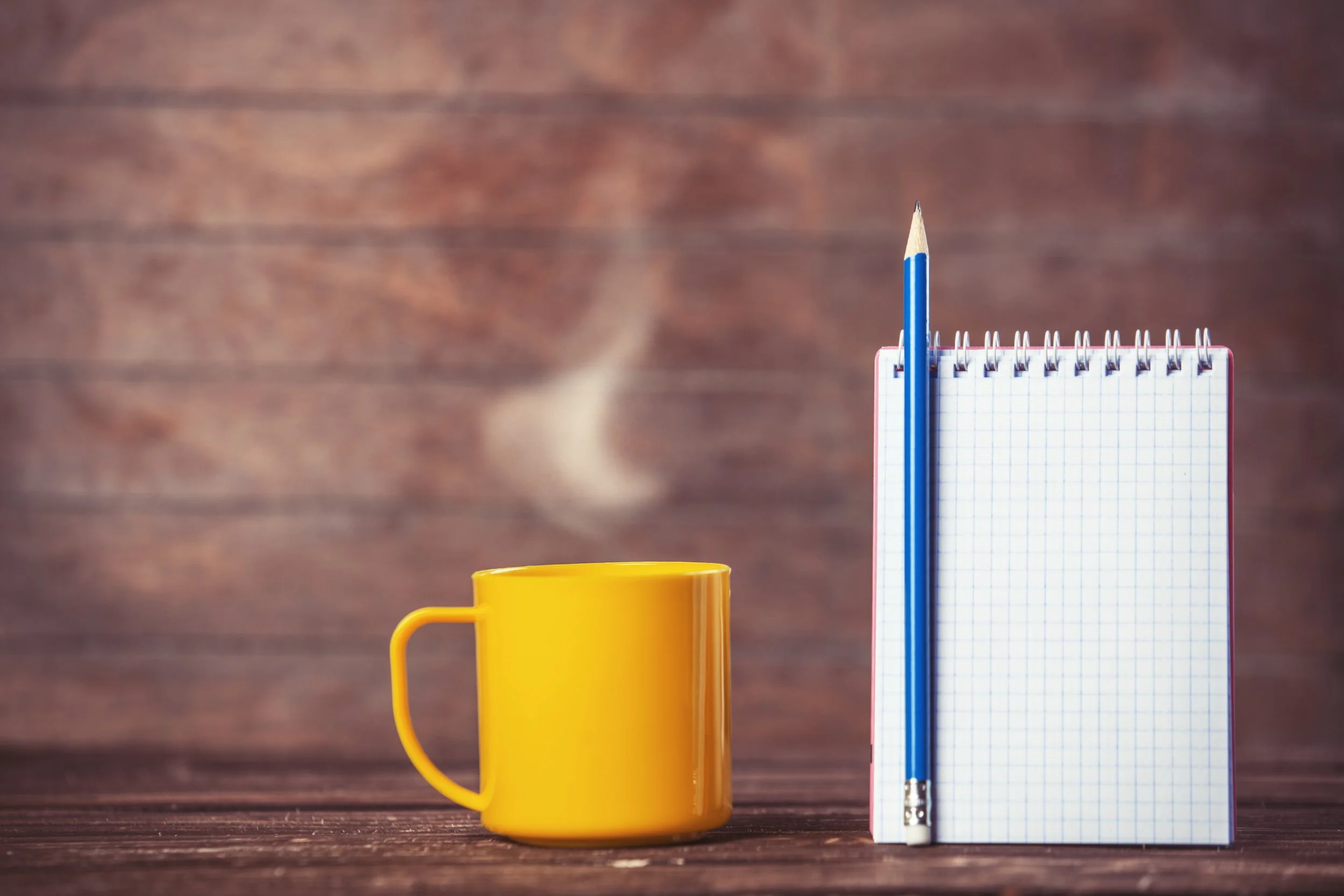 cup-of-coffee-and-notebook-on-wooden-background-2023-11-27-05-15-26-utc.jpg
