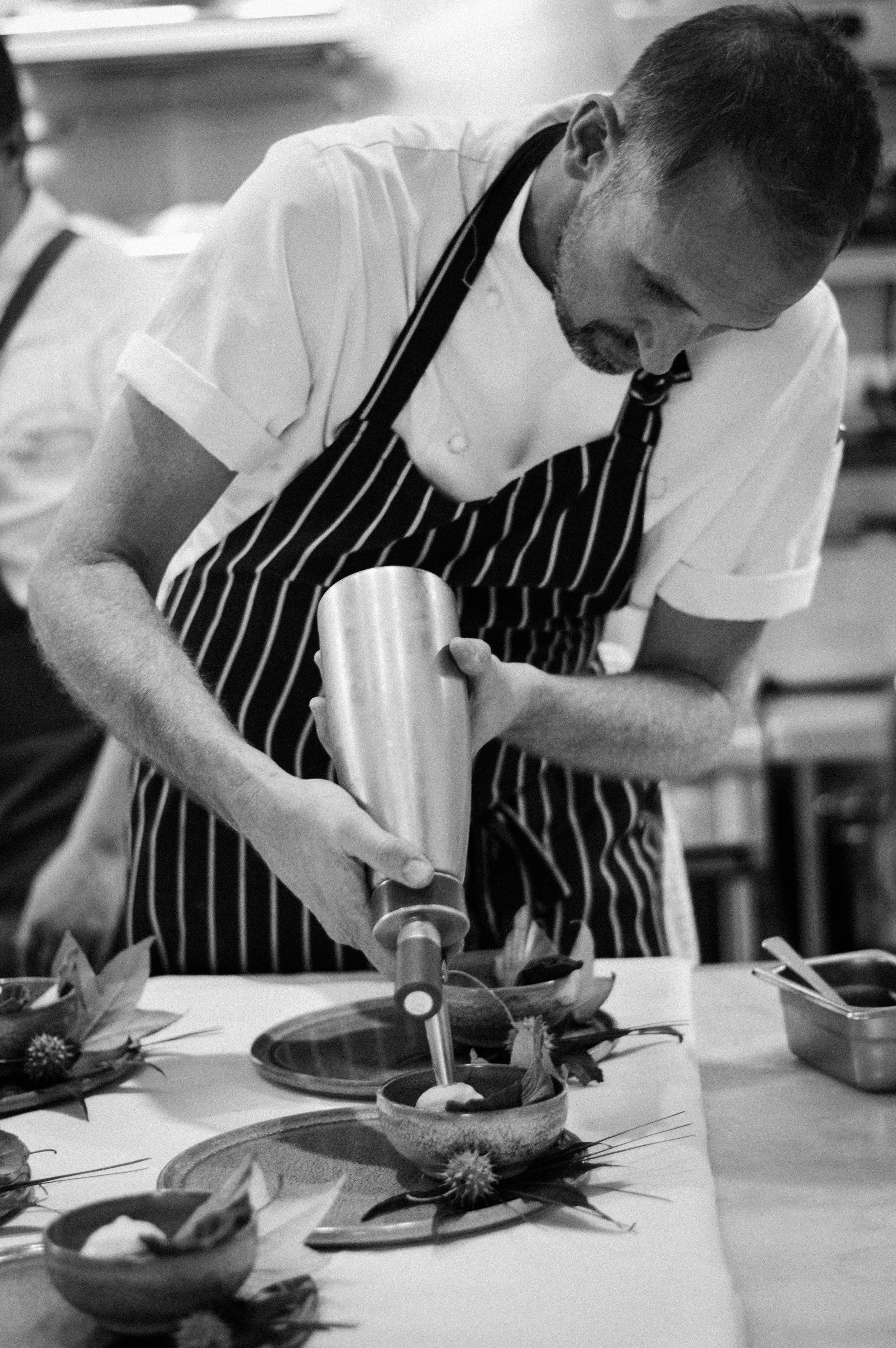 Cameron Matthews of The Long Apron preparing Mary Ann Dunn's dessert cours