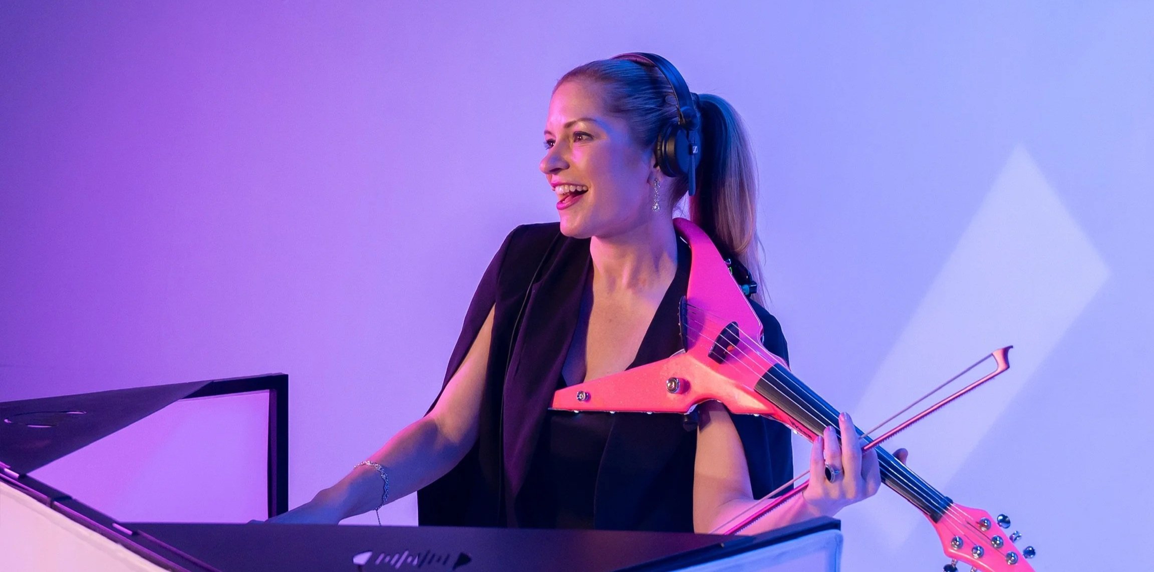 Brittany Cotto creating custom DJ and live violin performances during a live event.