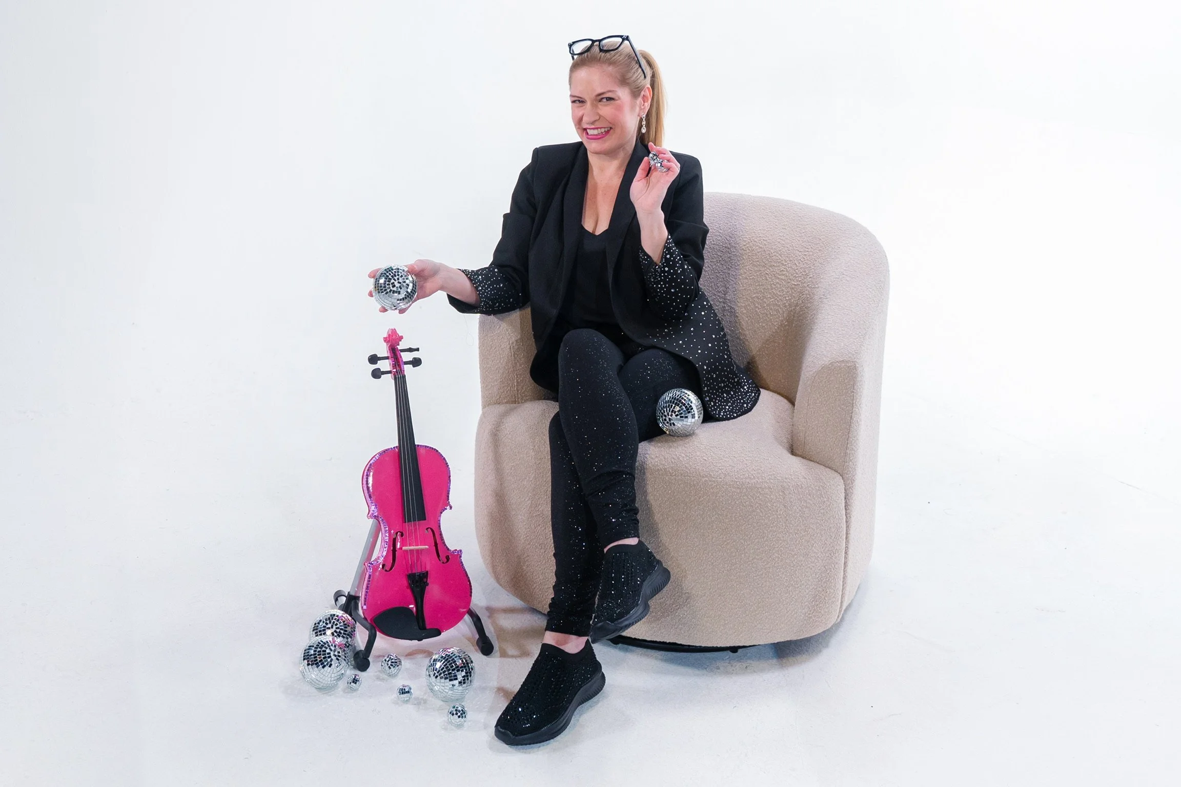 Brittany Cotto creating custom pink disco violin during a studio photoshoot.