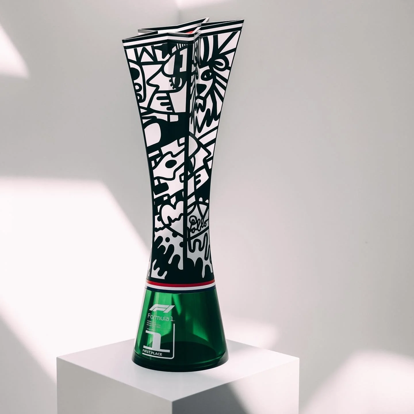 The official Dutch Grand Prix Trophy designed by contemporary Artist Pablo Lücker with black and white dream script art artwork on the top part and green Heineken base, labeled for first place in Formula 1 racing.