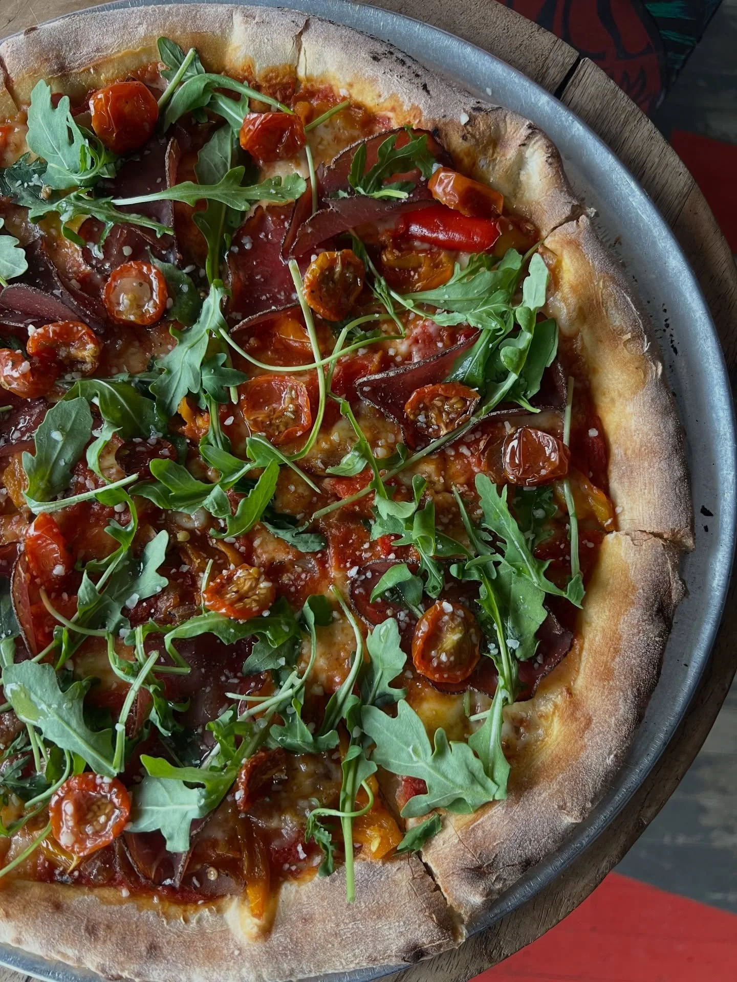 Our December pizza of the month is The Ditka 🧡💙 Bresaola Italian beef, confit roasted cherry tomatoes, sweet peppers, smoked onions, arugula, red sauce, parmesan, mozzarella.  Get it while you can!