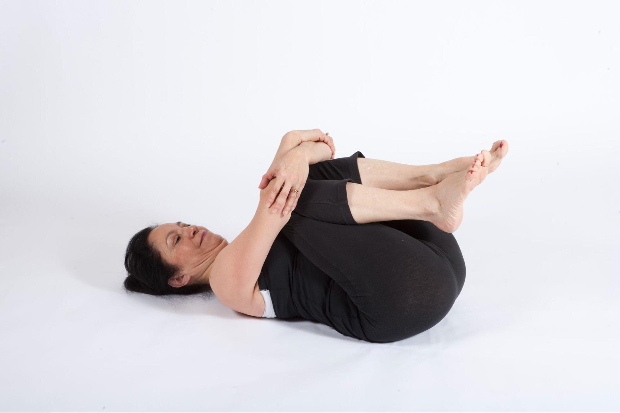 Wind-relieving pose yoga workout pavanamuktasana Vector Image