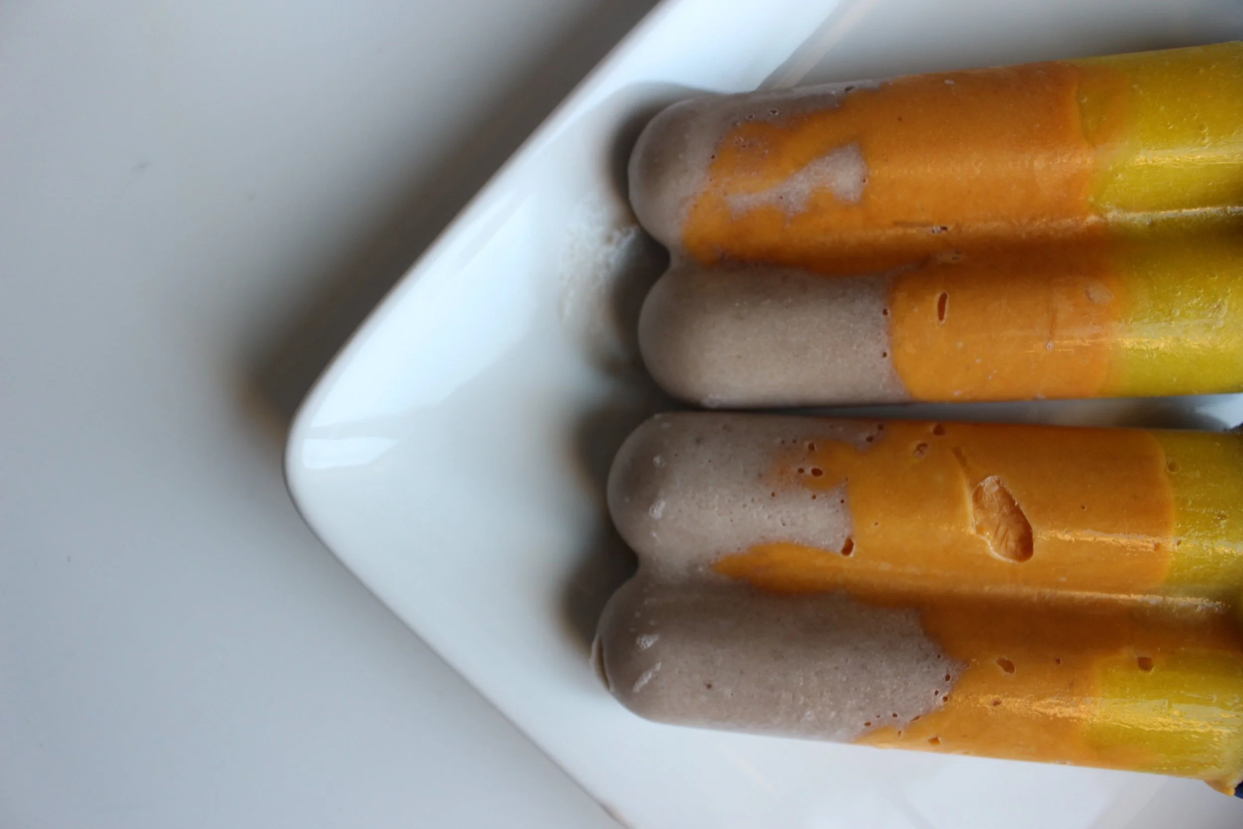 The colors of candy corn, but none of the preservatives. Candy corn popsicles | Me & the Moose #meandthemoose #candycorn #popsicles #puree #coconut #sweetpotato #pear #turmeric