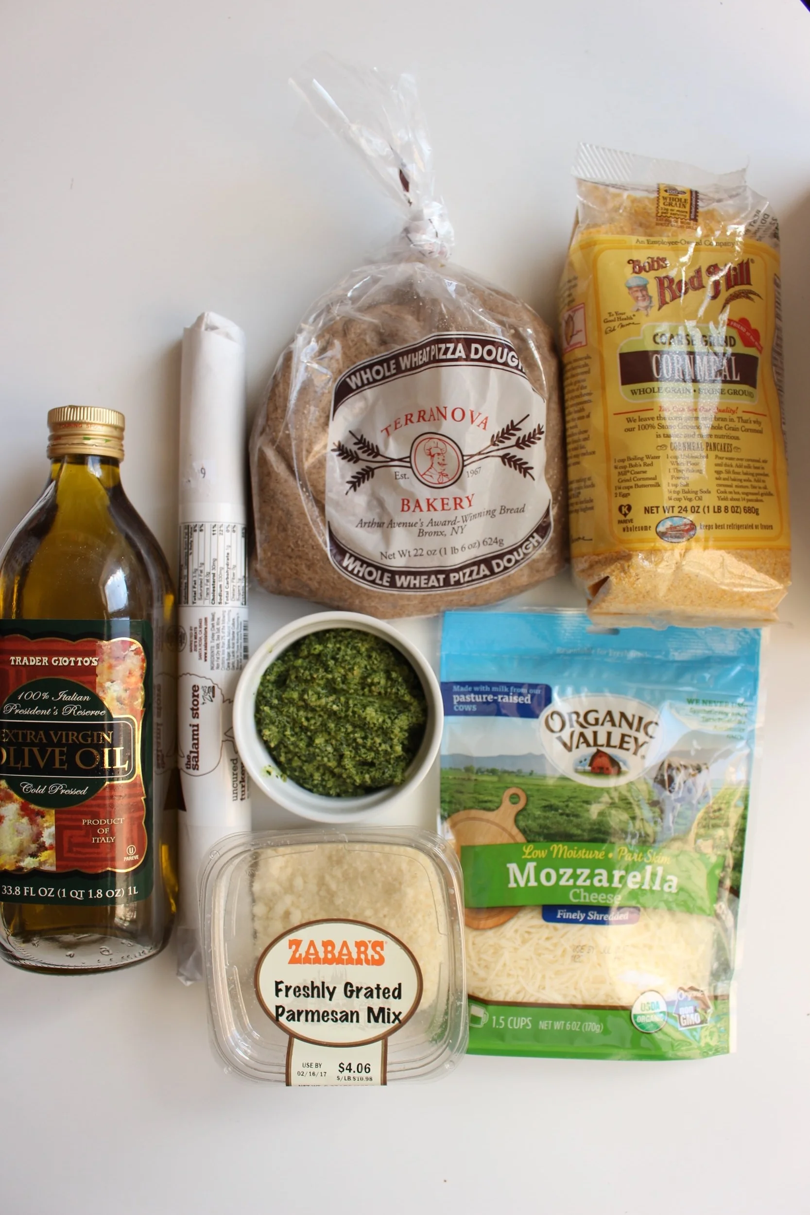 Healthy-ish pizza rolls | Me & The Moose. Whole wheat pizza crust, kale pesto, and turkey salami make these lunchbox friendly pizza rolls (just swap the walnuts in the kale pesto for sunflower or pumpkin seeds or leave them out entirely) a healthier pizza option. #meandthemoose #pizzarolls #healthypizzarecipes #healthypizza #lunchboxideas #lunchboxrecipes #lunch #pizza