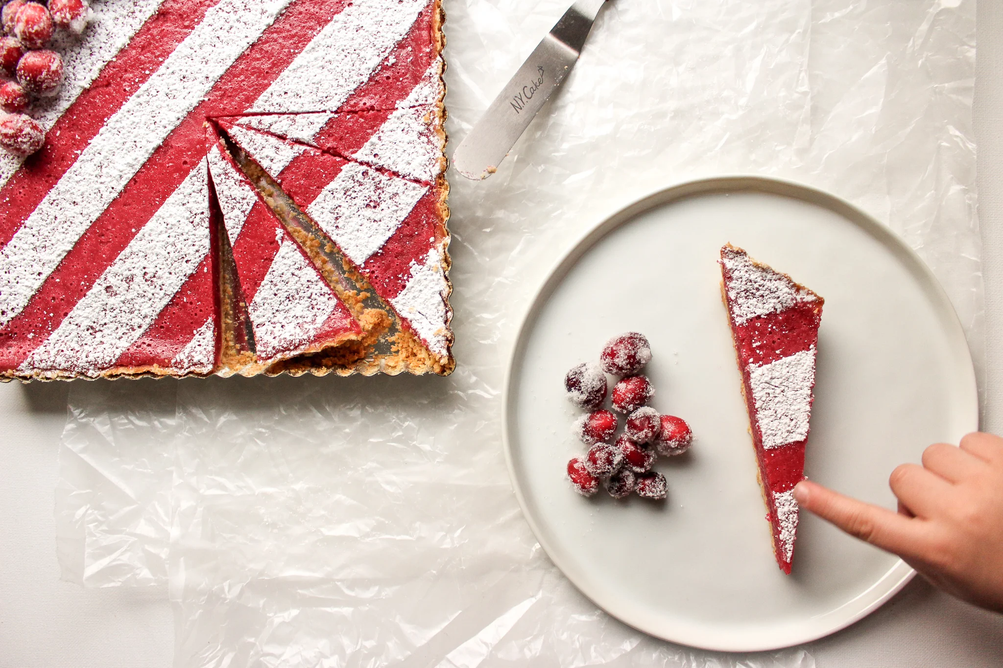Cranberry bars | Me & The Moose. These simple cranberry bars are a showstopper that looks complicated, but is actually easy to bake ahead and cut up for cookie swaps, office holiday parties, and your cookie tray. #cranberrybars #christmasbaking #lemonbars #meandthemoose #holidaydesserts #batchbaking