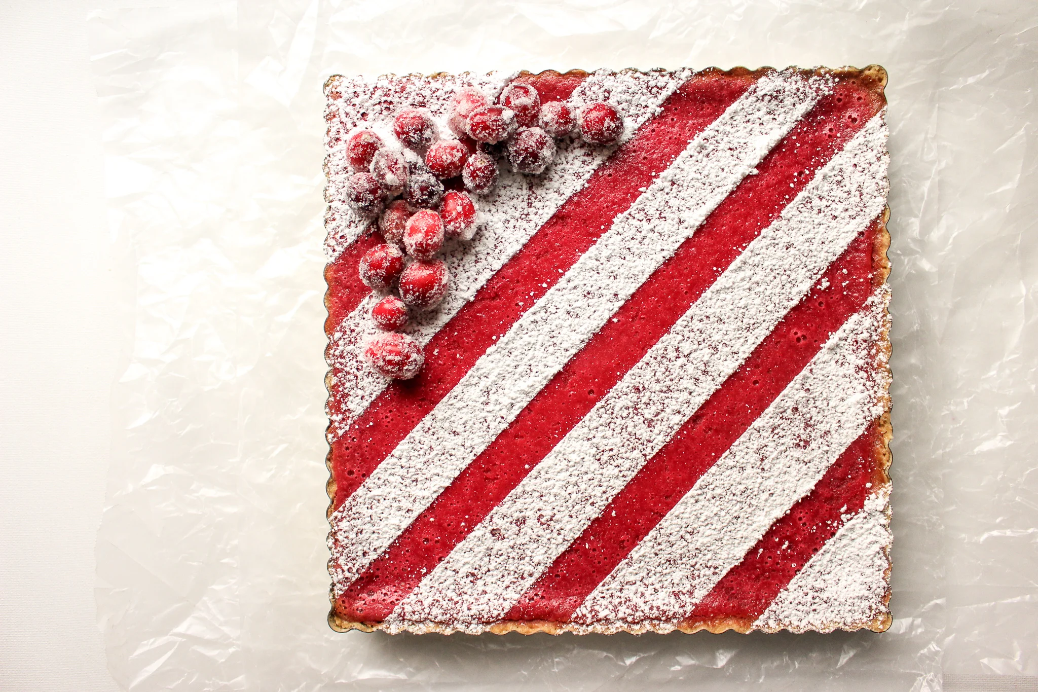Cranberry bars | Me & The Moose. These simple cranberry bars are a showstopper that looks complicated, but is actually easy to bake ahead and cut up for cookie swaps, office holiday parties, and your cookie tray. #cranberrybars #christmasbaking #lemonbars #meandthemoose #holidaydesserts #batchbaking