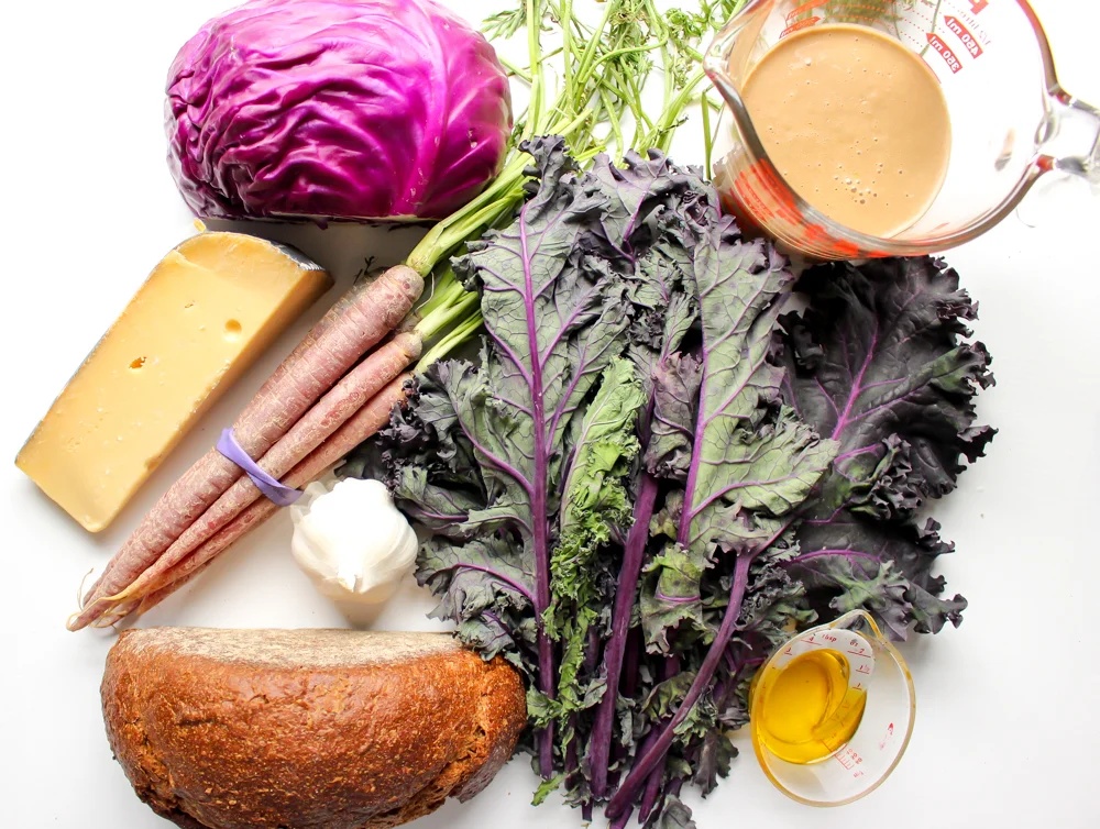 Purple kale and cabbage salad | Me & The Moose. A simple winter salad with greens, cabbage, roasted vegetables, and garlicky pumpernickel croutons tossed with a shallot vinaigrette is as filling and cozy as a salad can be. #meandthemoose #salad #wintersalad #saladrecipes #vegetarian #kale #cabbage #purplefoods