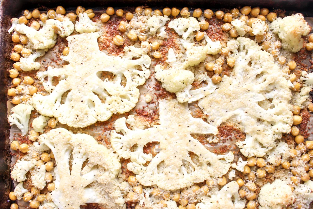Cacio e pepe cauliflower and chickpeas | Me & The Moose. This vegetarian sheetpan dish hits all the right notes of cheesy, creamy, crunchy, and delicious. It’s filled with protein and appealing to vegetarians and carnivores alike. #meandthemoose #sheetpanmeals #vegetarianrecipes #cauliflower #cheese #cacioepepe #chickpeas #vegetarian #vegetariandinners
