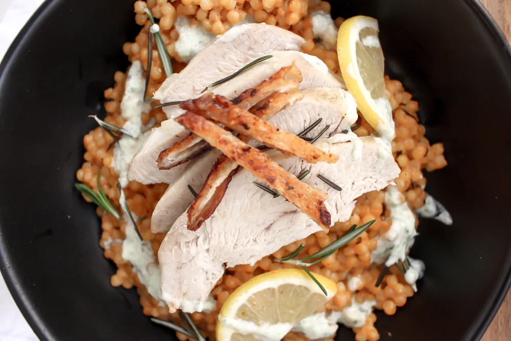 Lemon and rosemary turkey and couscous en cocotte | Me & The Moose. This one-pot (ish) meal has a low and slow cooking time, but is mostly hands-off and a much faster way to make delicious turkey breast without brining or drying out the meat. #turkeyrecipe #roastturkey #onepotmeal #avgolemono #israelicouscous #dinner #easydinner #healthydinner #encocotte
