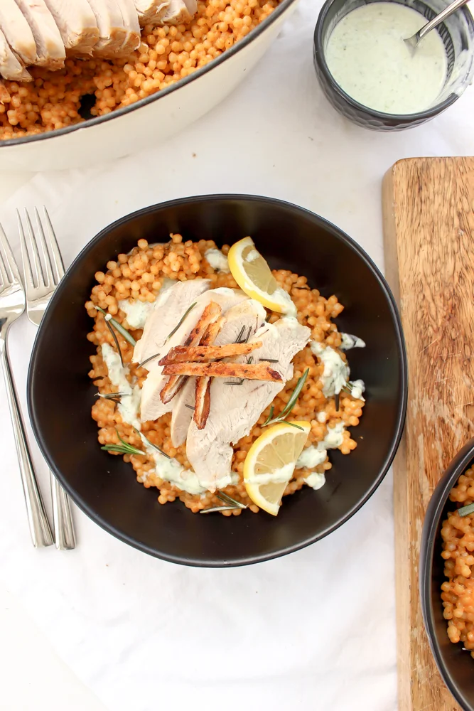 Lemon and rosemary turkey and couscous en cocotte | Me & The Moose. This one-pot (ish) meal has a low and slow cooking time, but is mostly hands-off and a much faster way to make delicious turkey breast without brining or drying out the meat. #turkeyrecipe #roastturkey #onepotmeal #avgolemono #israelicouscous #dinner #easydinner #healthydinner #encocotte