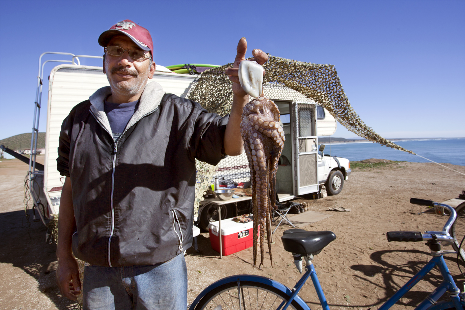 Armando holding up our dinner. Photo by Erik Anderson