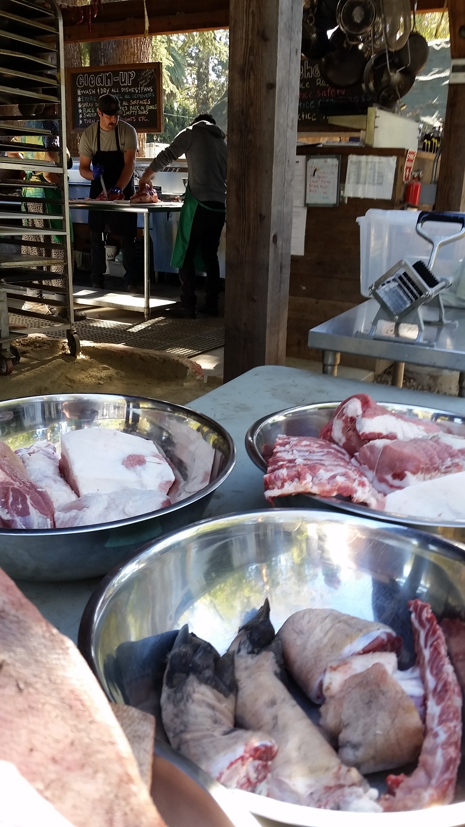 Chef David teaching a team how to break down one of the pigs raised on Pie Ranch. The meat is weighed, labeled and frozen for future use at events on the farm. 
