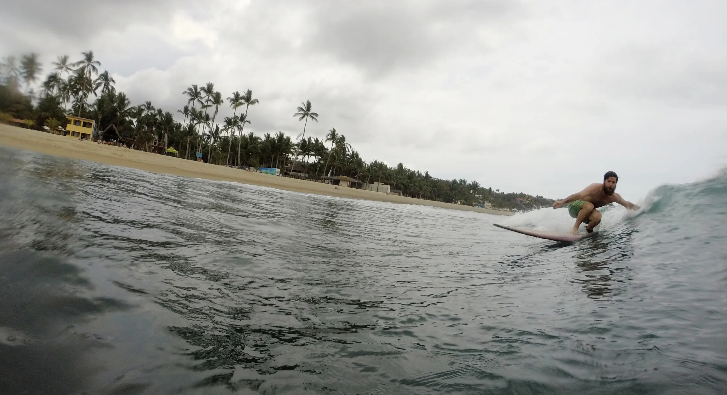 Erik surfing! Yellow building in upper left is the Sayulita Trailer Park. Photo Cred-Aldo Rohlfs