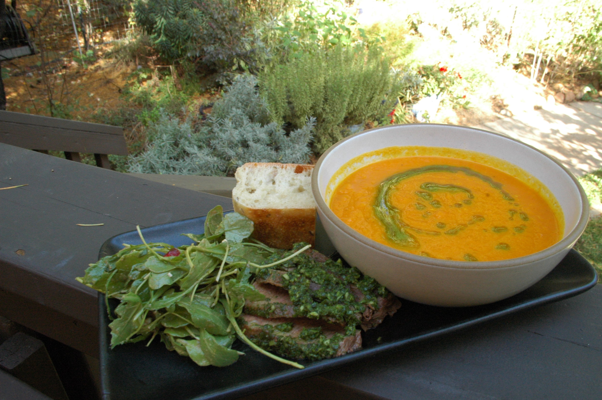 Carrot soup with parsley oil, chimichurri steak and arugula salad