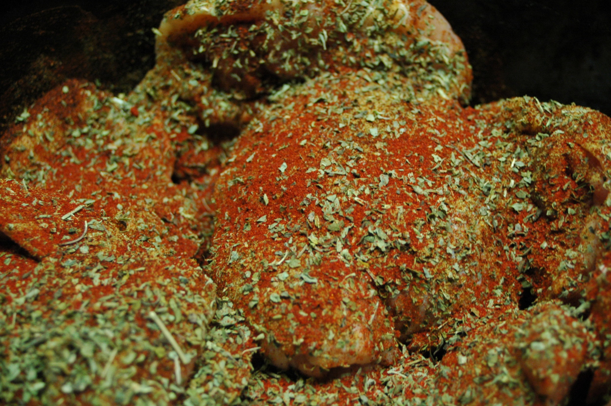 Chicken thighs sprinkled with rub ingredients