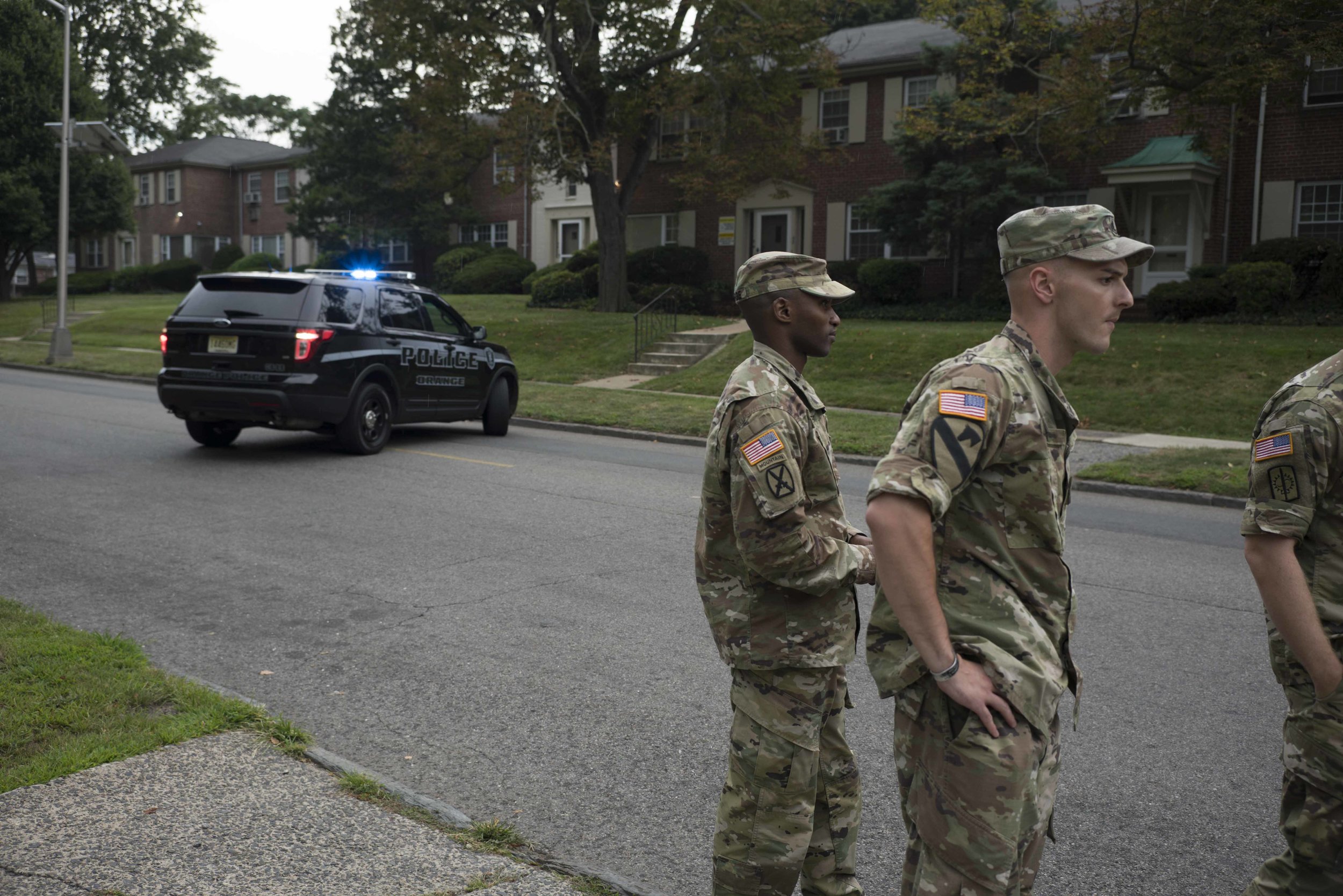  Orange police leave the scene after responding to a 9-11 call from recruiters reporting that a man who appeared to be armed punched their van. 