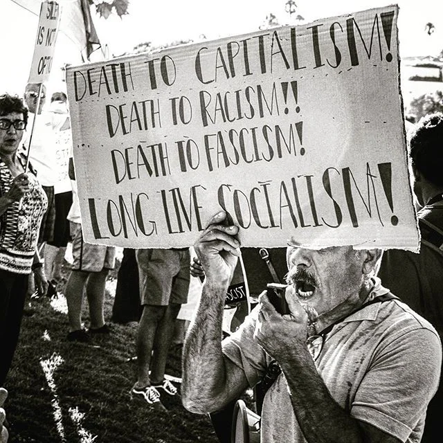 A protestor walks the beach on Sunday, megaphone slung under his arm as he shouts into a reciever condemning government leaders from across the polictical spectrum.
.
.
.
.
#blackandwhitephotography #bnw  #blackandwhitehumans #blackandwhite #blacknwh