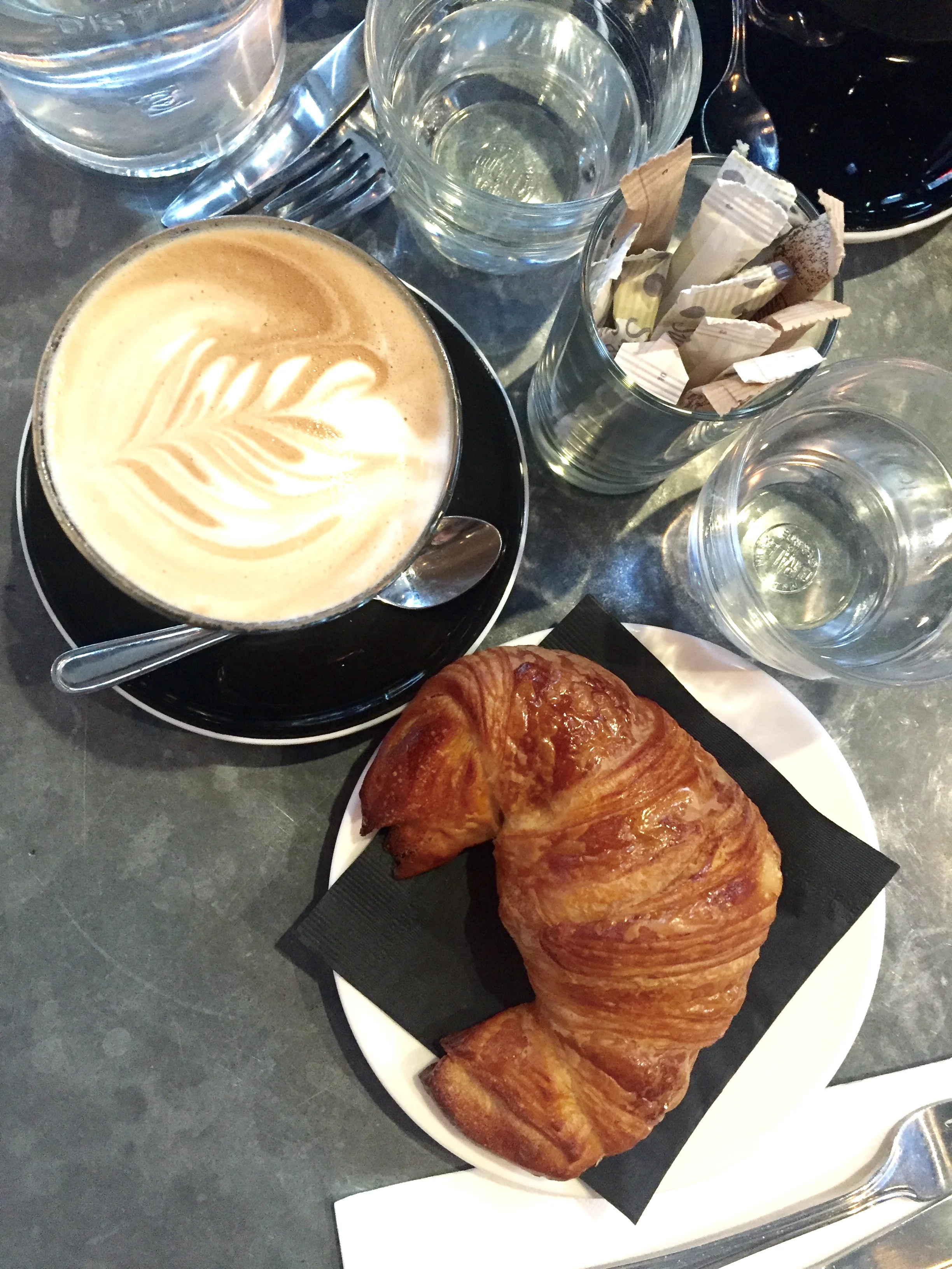 Cafe au lait and a butter croissant of flaky perfection.
